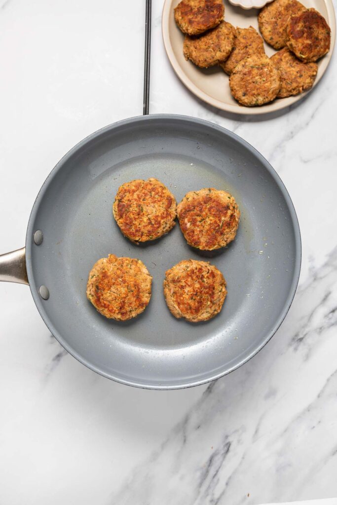 tuna potato patties golden brown in a skillet