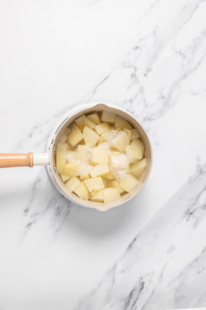 cooked potato chunks on a saucepan