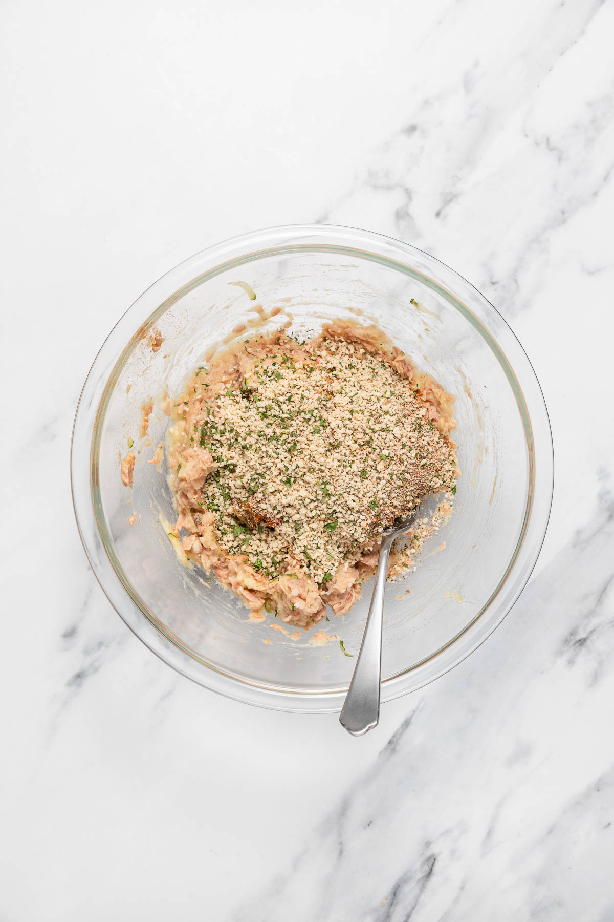 Dry ingredients being added to tuna mixture